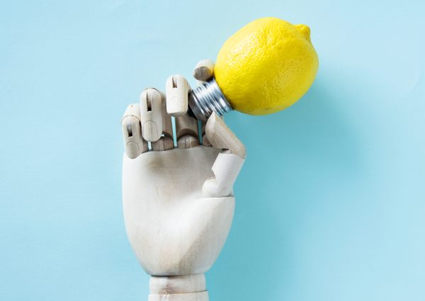 Robot hand holding a lemon bulb